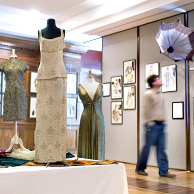 Theater costumes on display in a gallery.